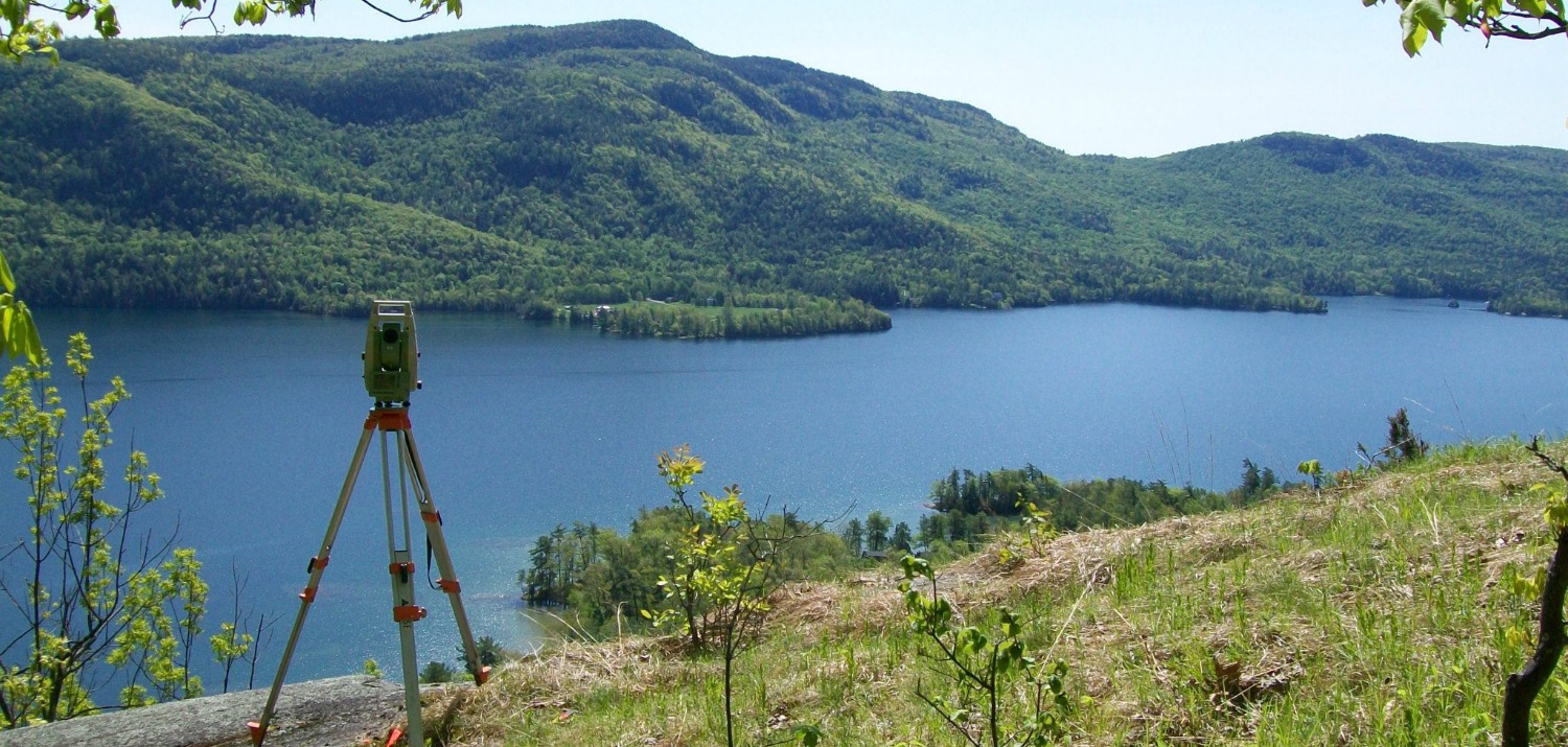 pituresque view of lake george ny with surveying equipment
